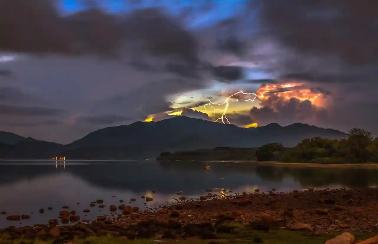 Distant lightning — use sparingly for a cinematic but sleep-friendly storm Forked lightning illuminating a distant storm cloud over the horizon